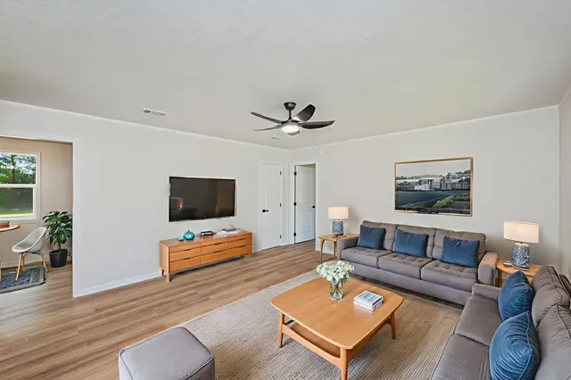a living room with furniture and a flat screen tv