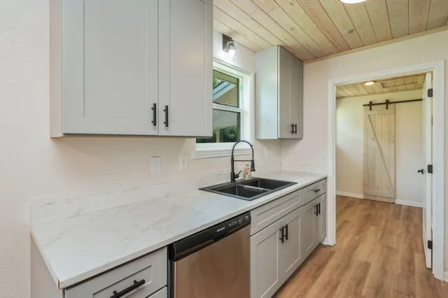 a kitchen that has a sink and a stove