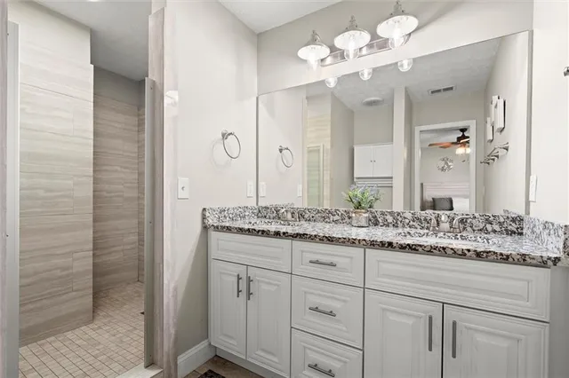 a bathroom with a granite countertop sink vanity granite and a mirror