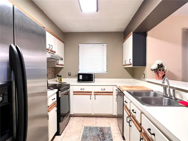 a kitchen with stainless steel appliances granite countertop a sink and a stove