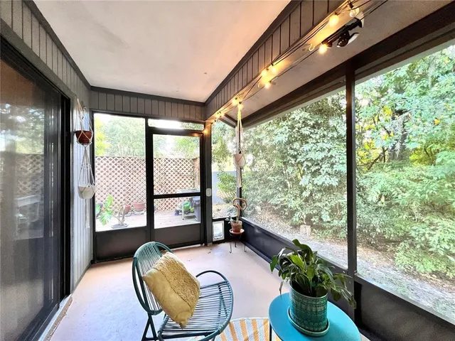 a view of a balcony with chair and potted plants