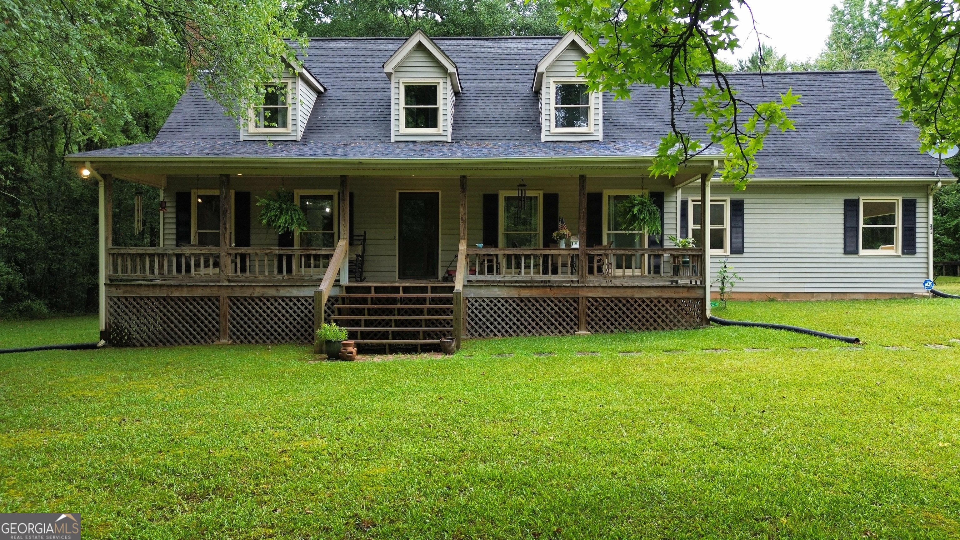 a view of a house with garden and deck