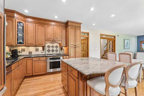 a kitchen with granite countertop wooden cabinets and stainless steel appliances