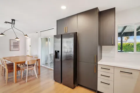 a kitchen with stainless steel appliances granite countertop a refrigerator sink and stove