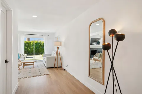 a living room with furniture a fireplace and a floor to ceiling window