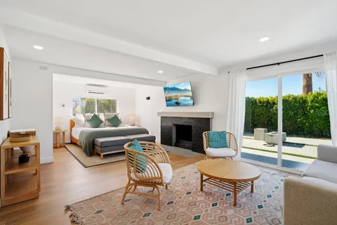 a living room with furniture a rug and a flat screen tv