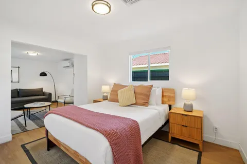 a bedroom with a bed and a lamp