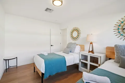 a bedroom with a bed and a painting on the wall