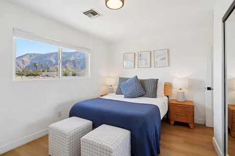 a bedroom with a bed and a mirror