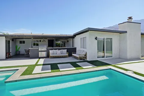 a view of a house with pool porch and furniture