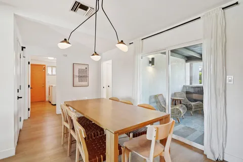 a kitchen view with stainless steel appliances a dining table chairs and granite counter tops