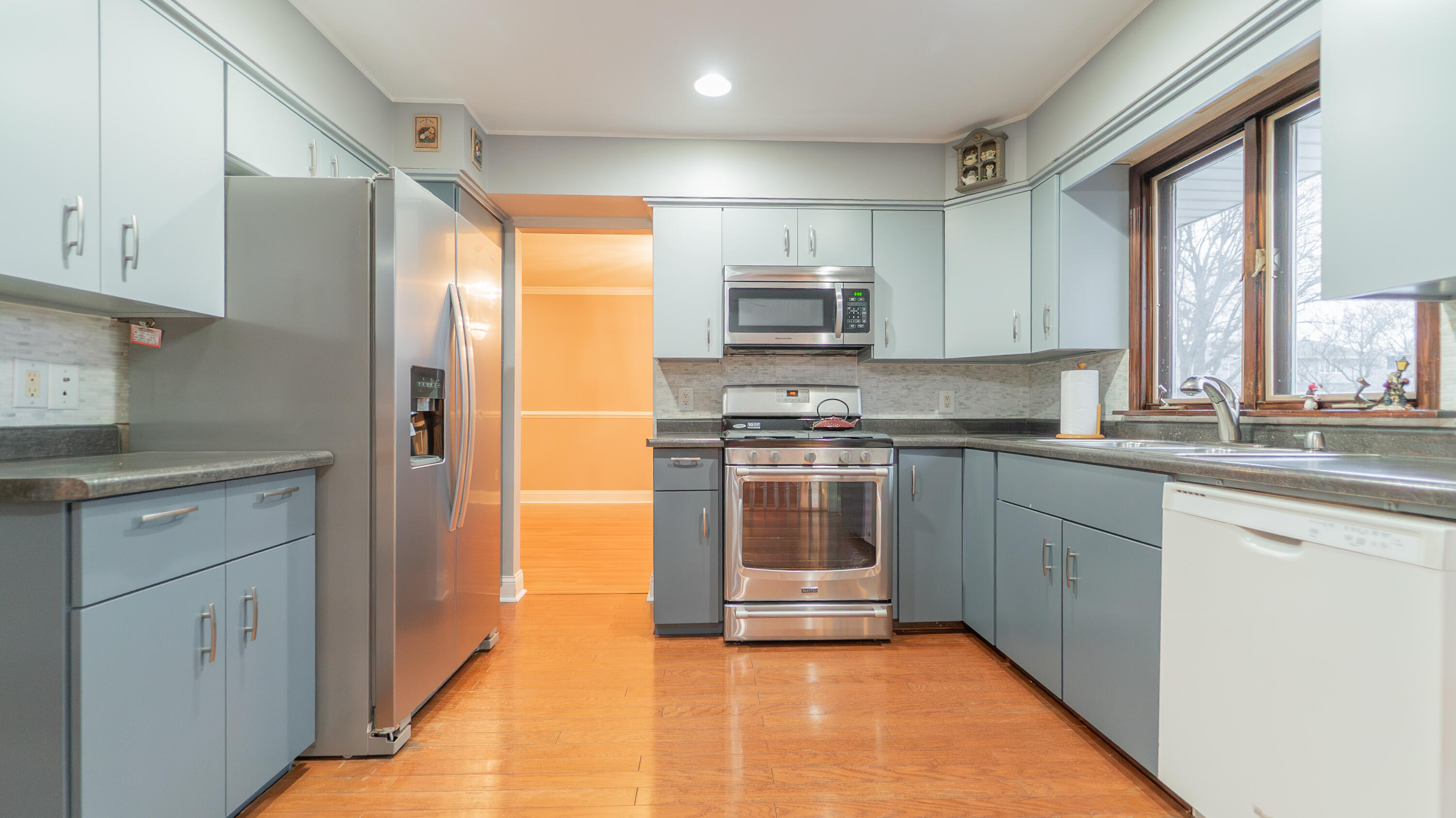 9439 Walnut Drive Munster, IN 46321 - Photo 12 of 40 a kitchen with kitchen island granite countertop white cabinets and stainless steel appliances