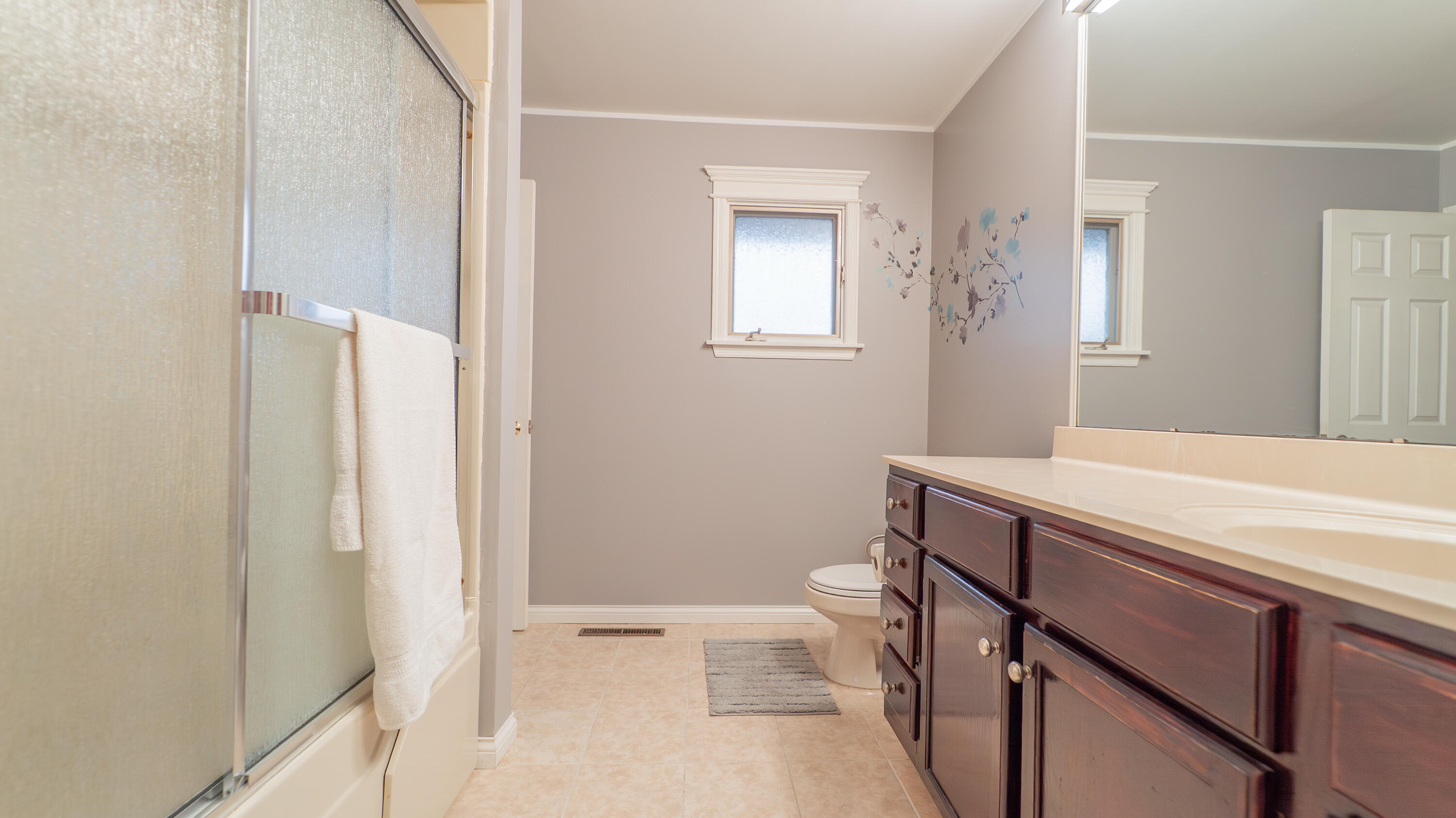 9439 Walnut Drive Munster, IN 46321 - Photo 21 of 40 a bathroom with a sink a toilet a shower and a window
