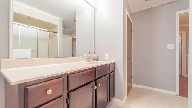a room with a sink cabinets and a wooden floor