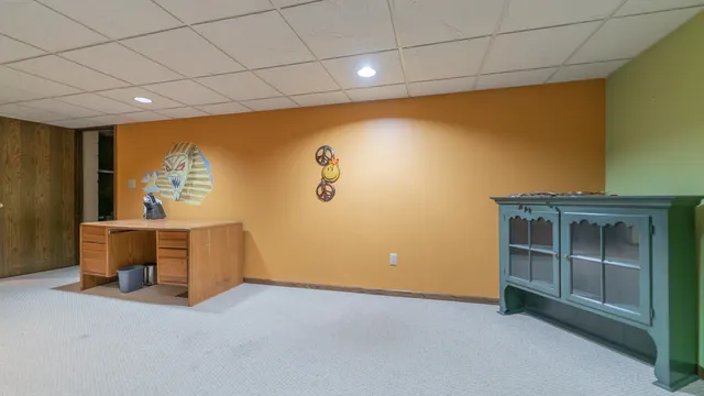 a view of a livingroom with furniture and a kitchen