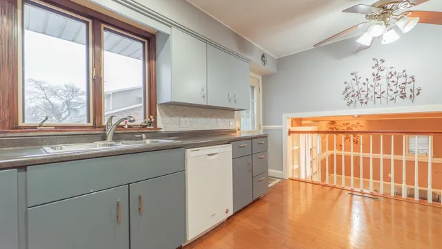 a kitchen with stainless steel appliances granite countertop a sink and a large window