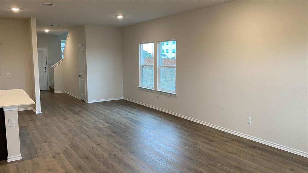 107 Hunters Way Canton, TX 75103 - Photo 13 of 23 an empty room with wooden floor and windows