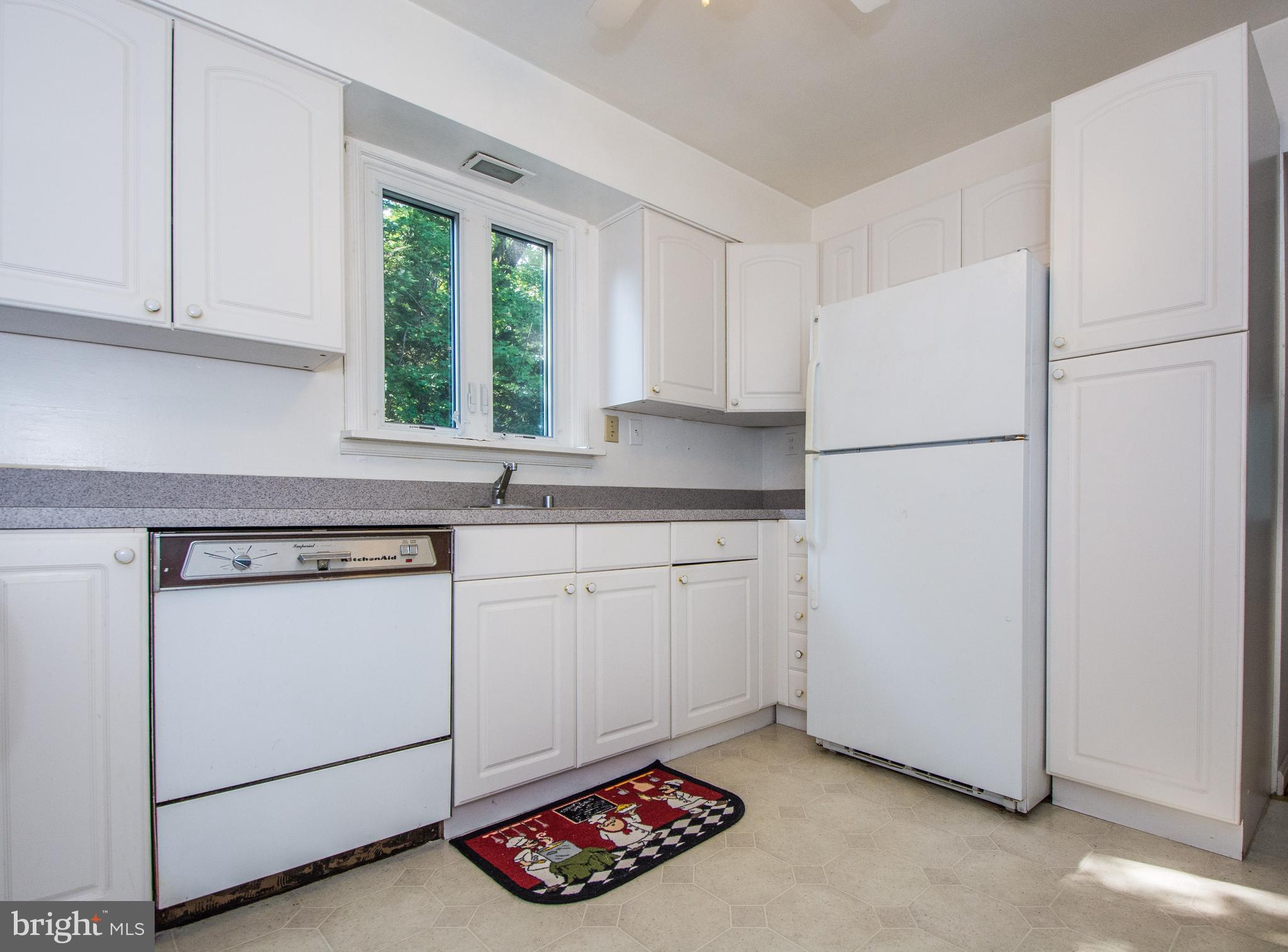 803 Quincy Road Baltimore, MD 21286 - Photo 11 of 28 a kitchen with white cabinets and white appliances