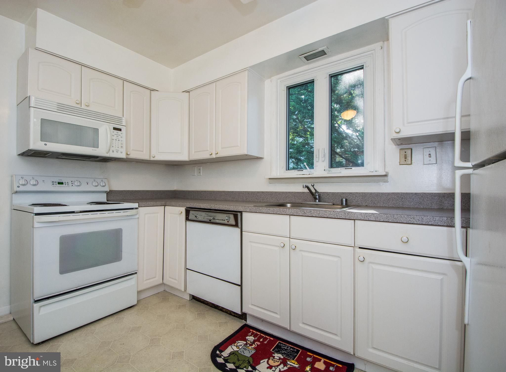 803 Quincy Road Baltimore, MD 21286 - Photo 12 of 28 a kitchen with granite countertop white cabinets stainless steel appliances and a sink