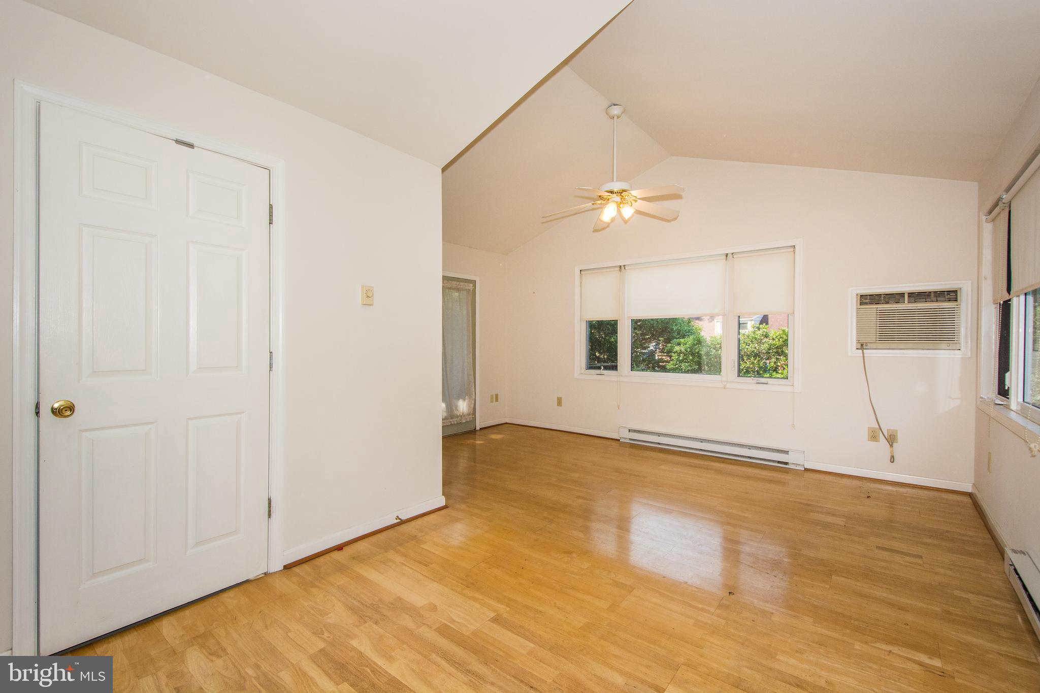 803 Quincy Road Baltimore, MD 21286 - Photo 13 of 28 wooden floor in an empty room with a window