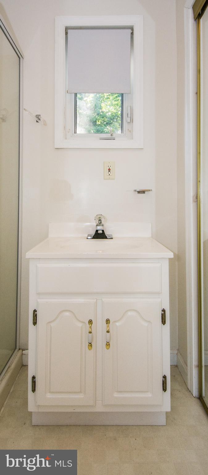 803 Quincy Road Baltimore, MD 21286 - Photo 15 of 28 a close view of a sink a window and a white vanity