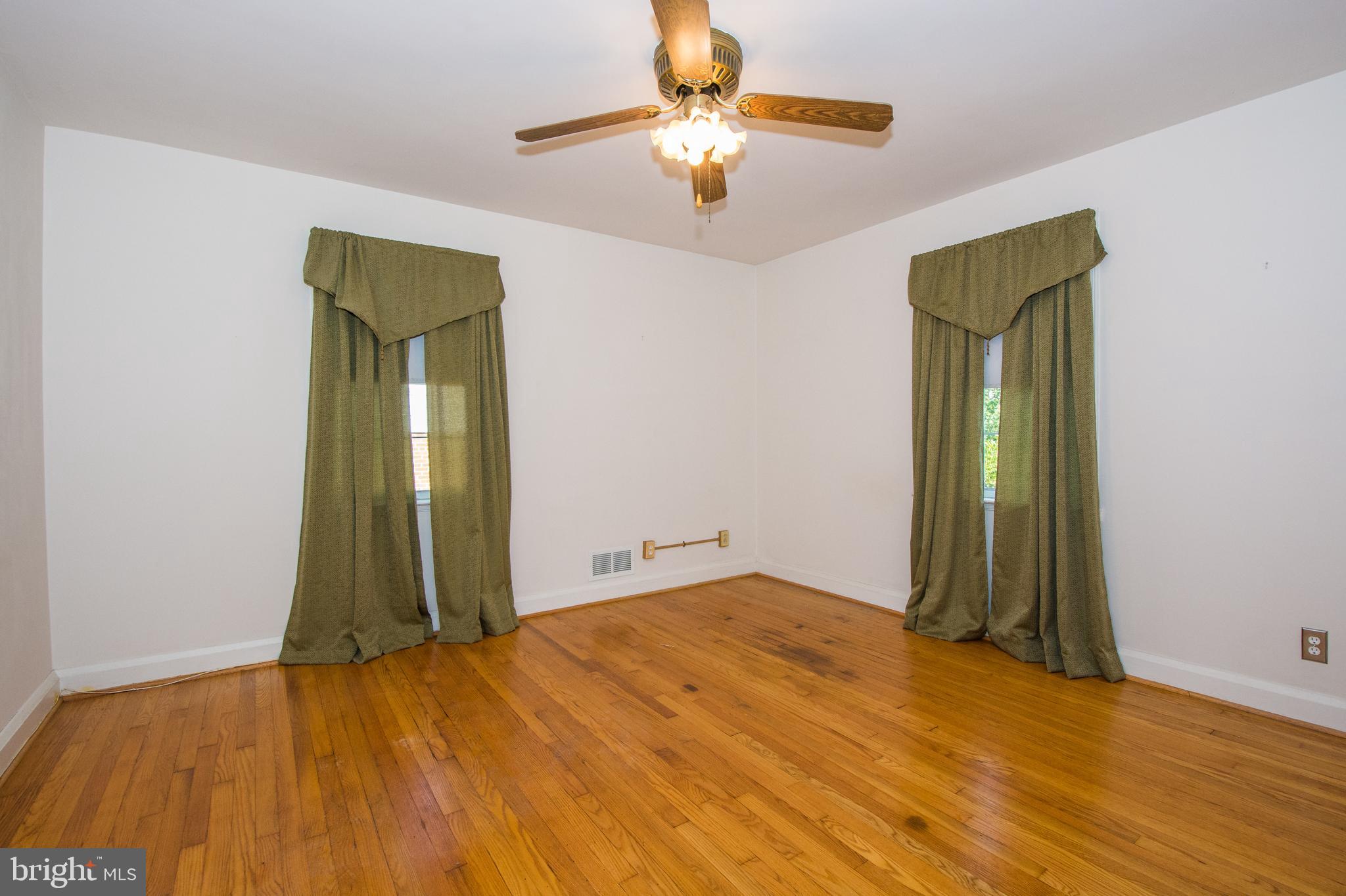 803 Quincy Road Baltimore, MD 21286 - Photo 17 of 28 a view of a room with wooden floor and a ceiling fan