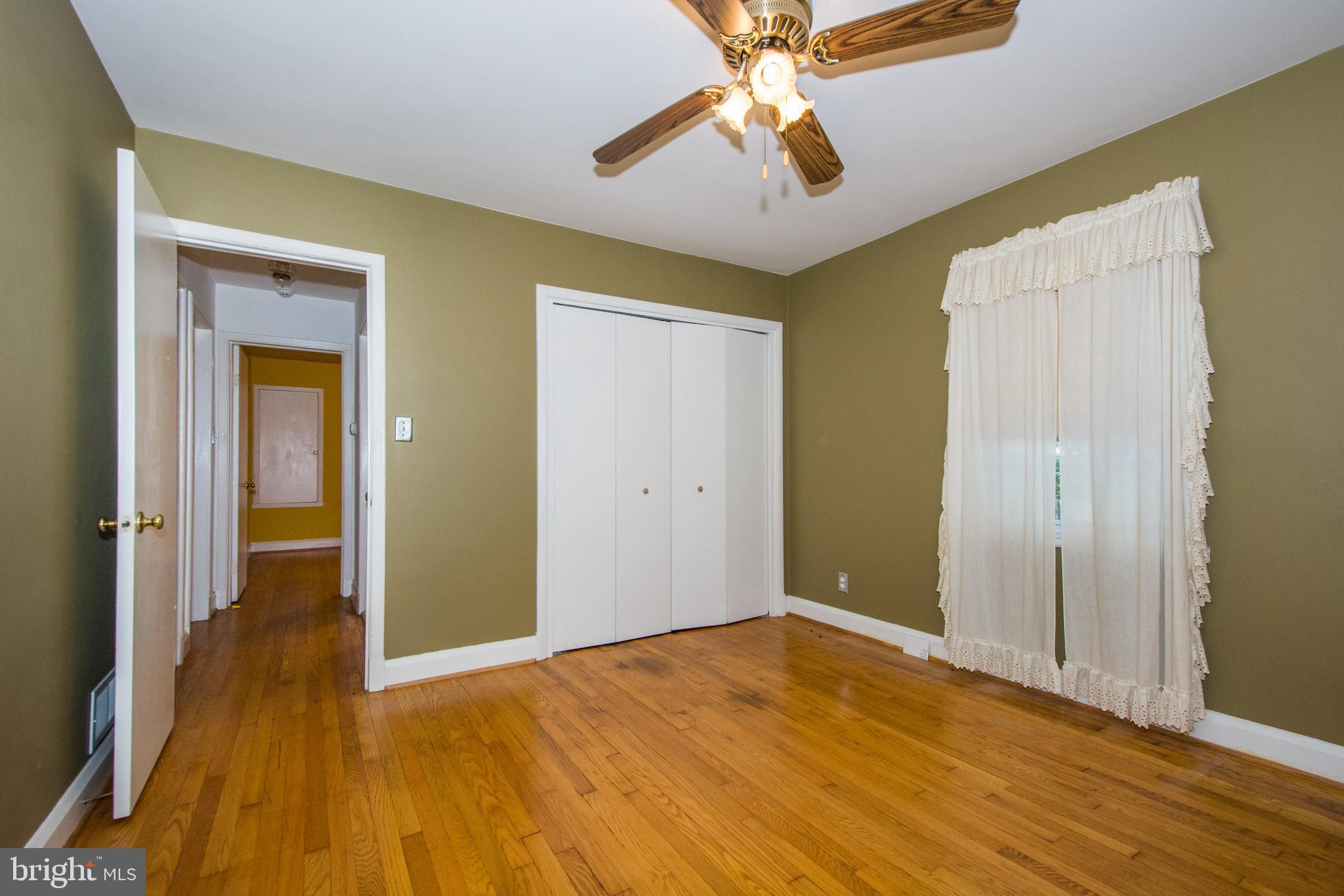 803 Quincy Road Baltimore, MD 21286 - Photo 19 of 28 wooden floor in an empty room with a chandelier fan