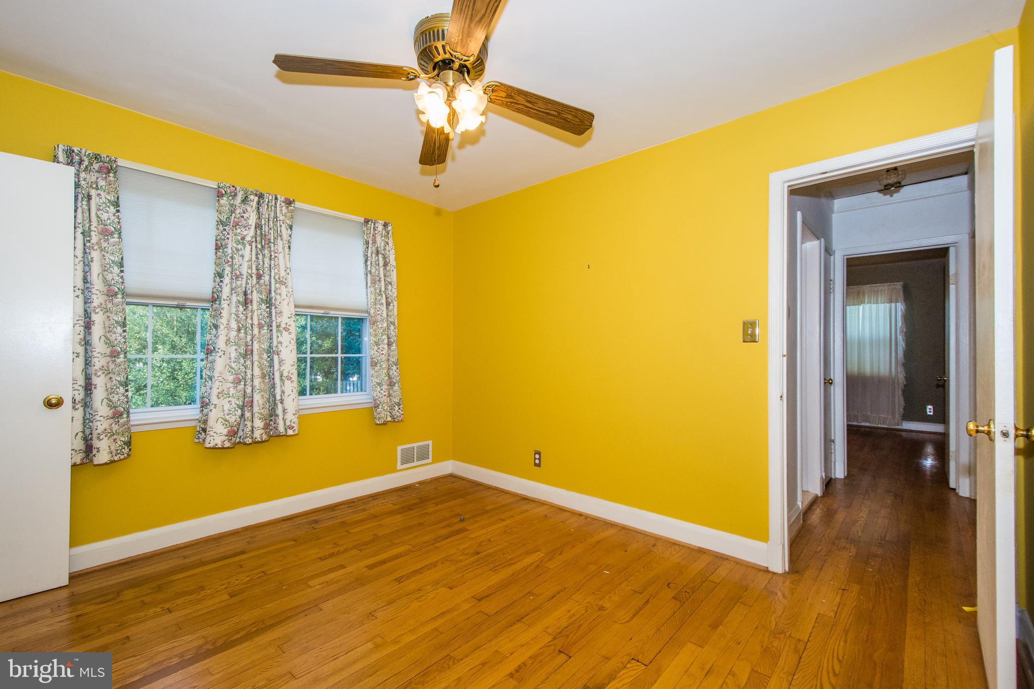 803 Quincy Road Baltimore, MD 21286 - Photo 21 of 28 a view of empty room with wooden floor and fan