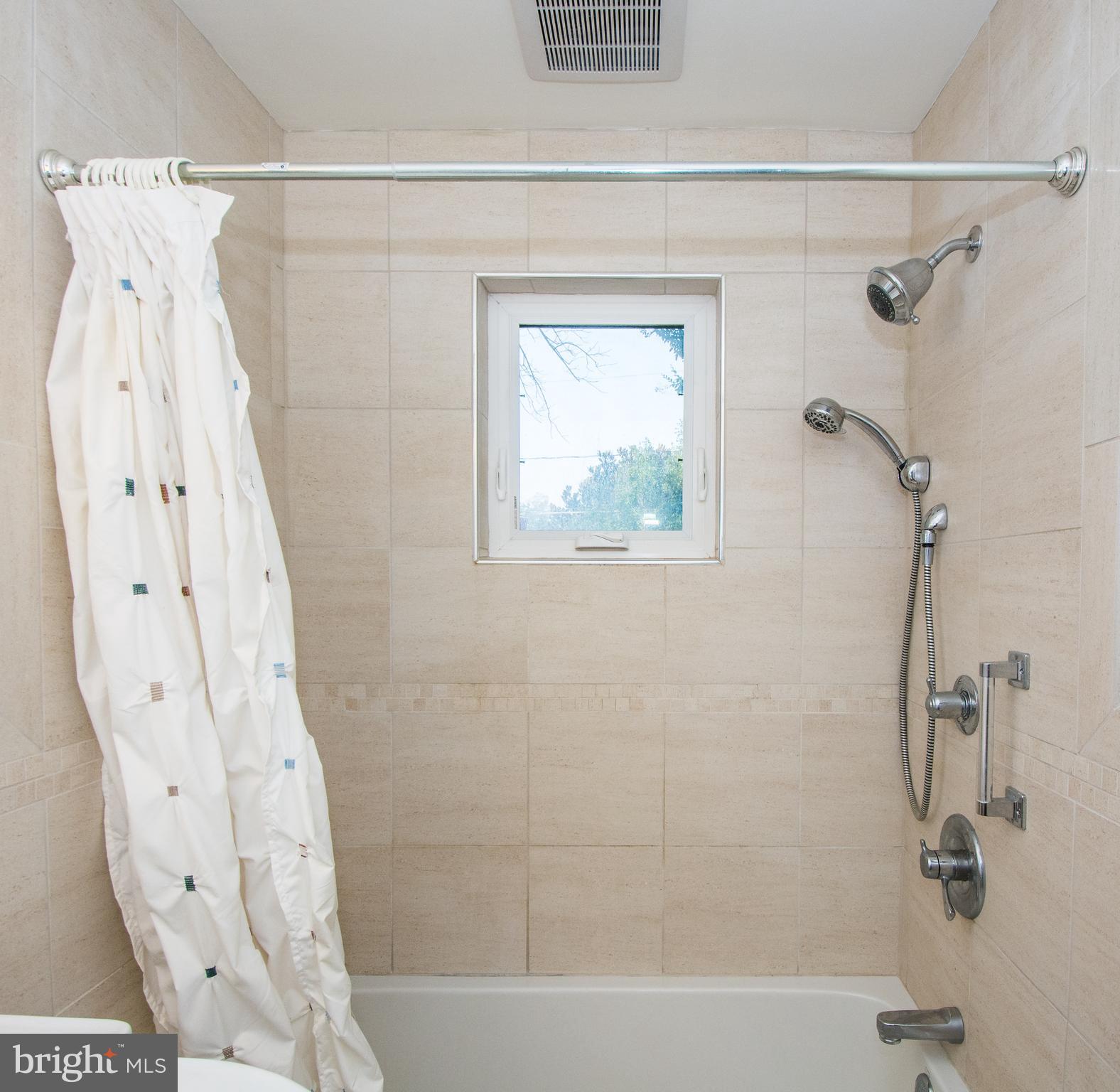 803 Quincy Road Baltimore, MD 21286 - Photo 23 of 28 a bathroom with a shower and a tub