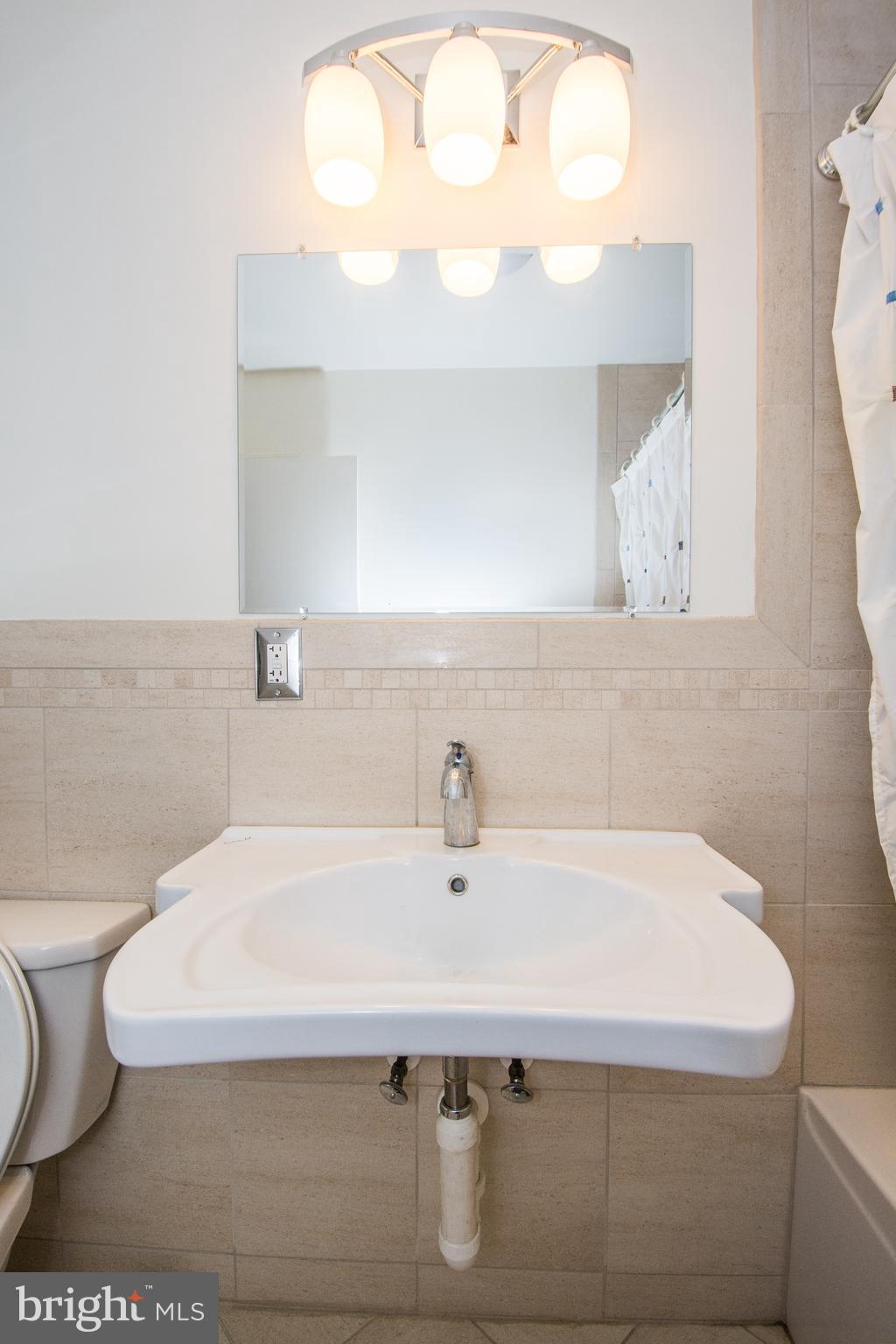 803 Quincy Road Baltimore, MD 21286 - Photo 25 of 28 a bathroom with a sink and a toilet