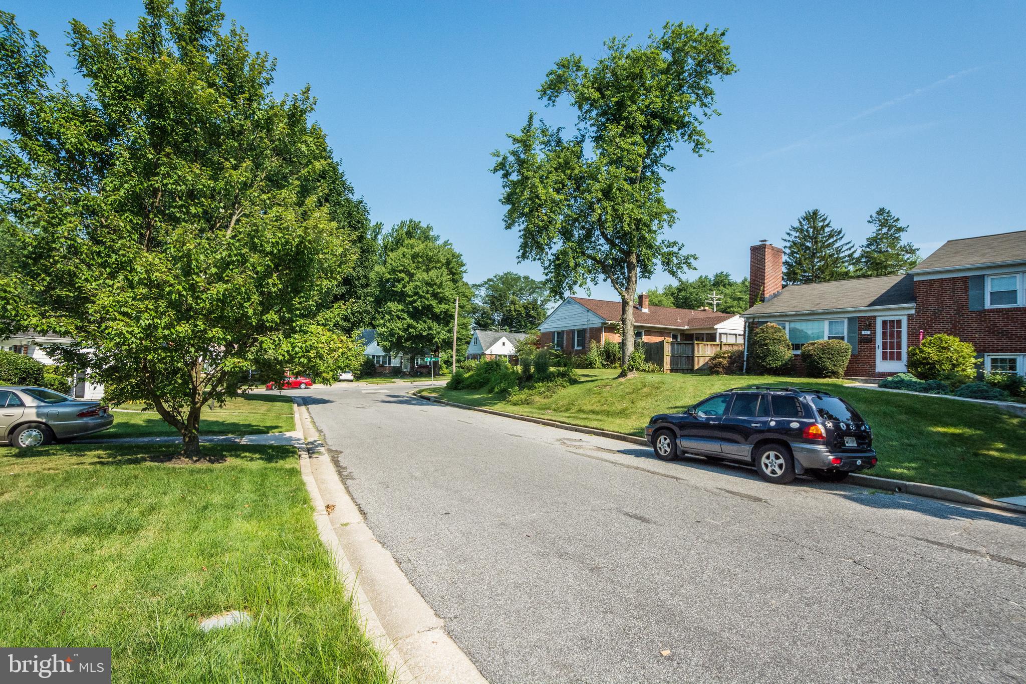 803 Quincy Road Baltimore, MD 21286 - Photo 28 of 28 a car parked in front of a house with a yard