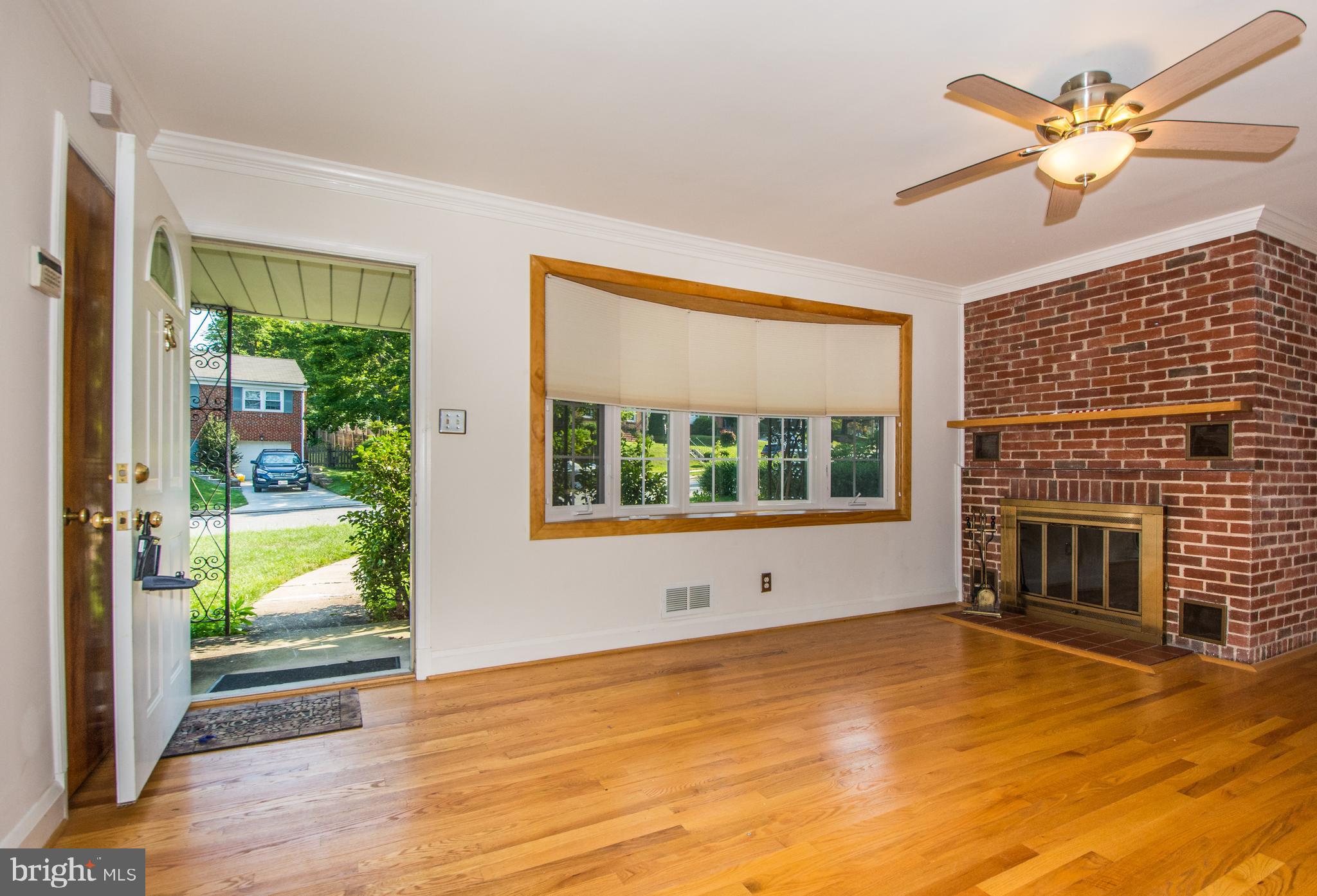 803 Quincy Road Baltimore, MD 21286 - Photo 5 of 28 a view of empty room with a fireplace and wooden floor