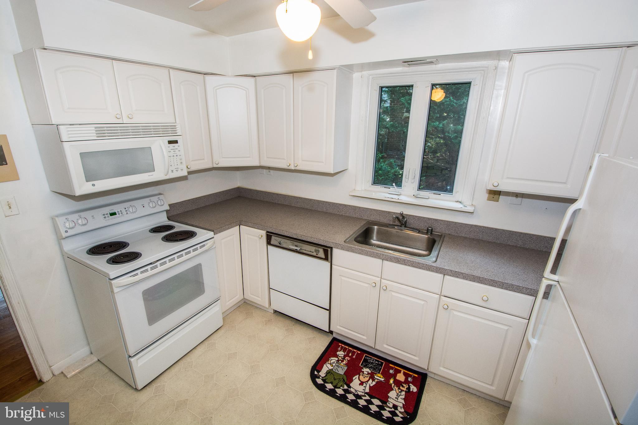 803 Quincy Road Baltimore, MD 21286 - Photo 9 of 28 a kitchen with white cabinets and white appliances