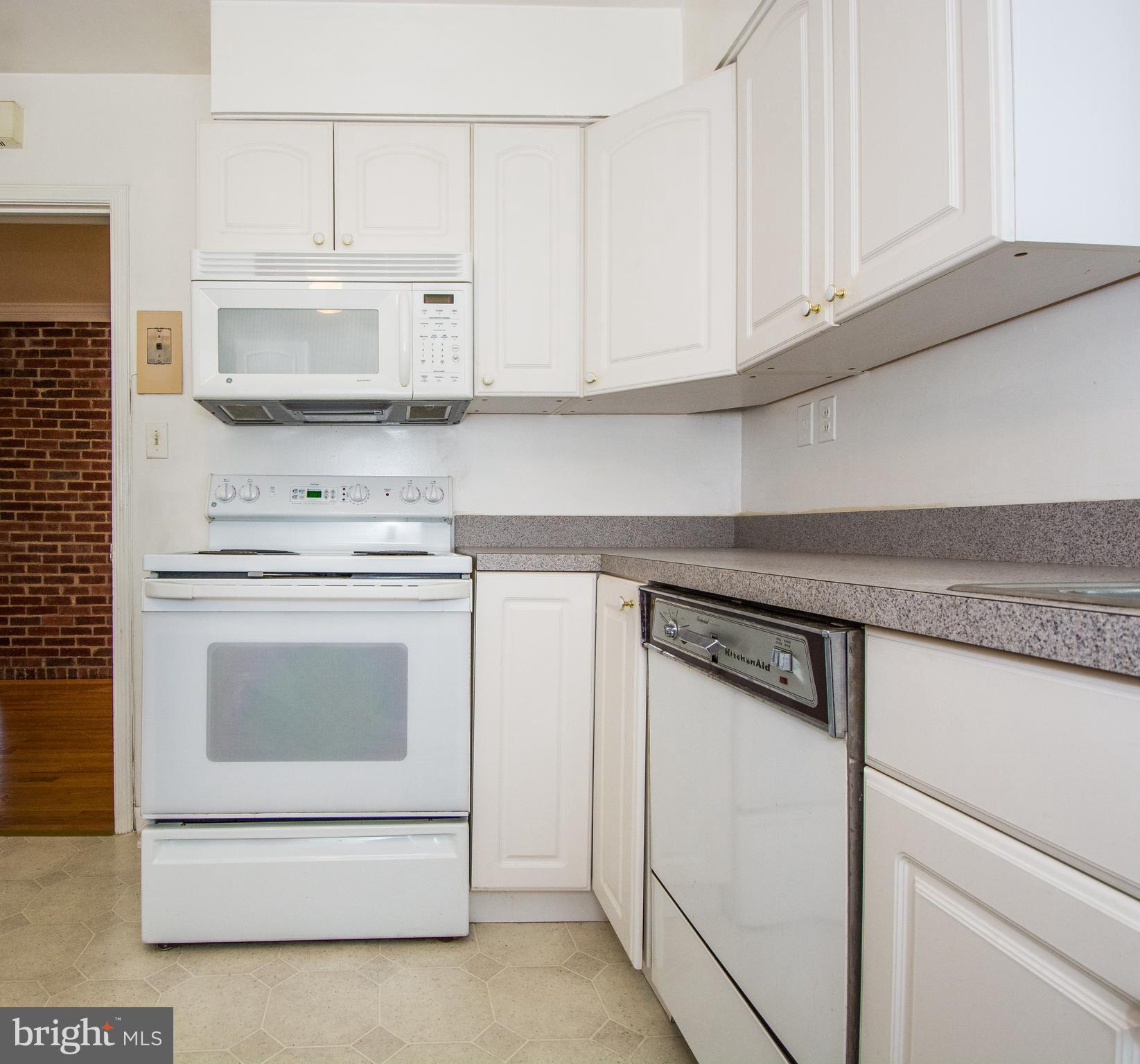 803 Quincy Road Baltimore, MD 21286 - Photo 10 of 28 a kitchen with white cabinets and white appliances
