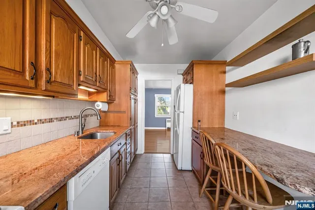 a kitchen with sink cabinets and stove