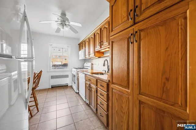 a kitchen with stainless steel appliances a refrigerator and cabinets