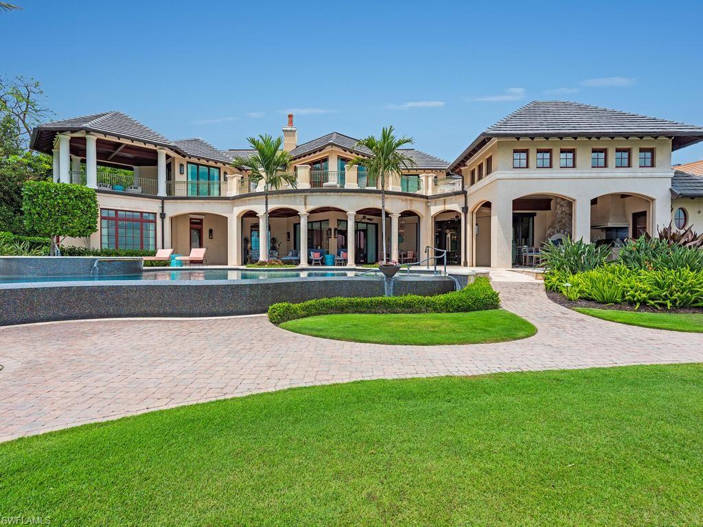 840 Admiralty Parade Naples, FL 34102 - Photo 14 of 50 a front view of a house with a yard