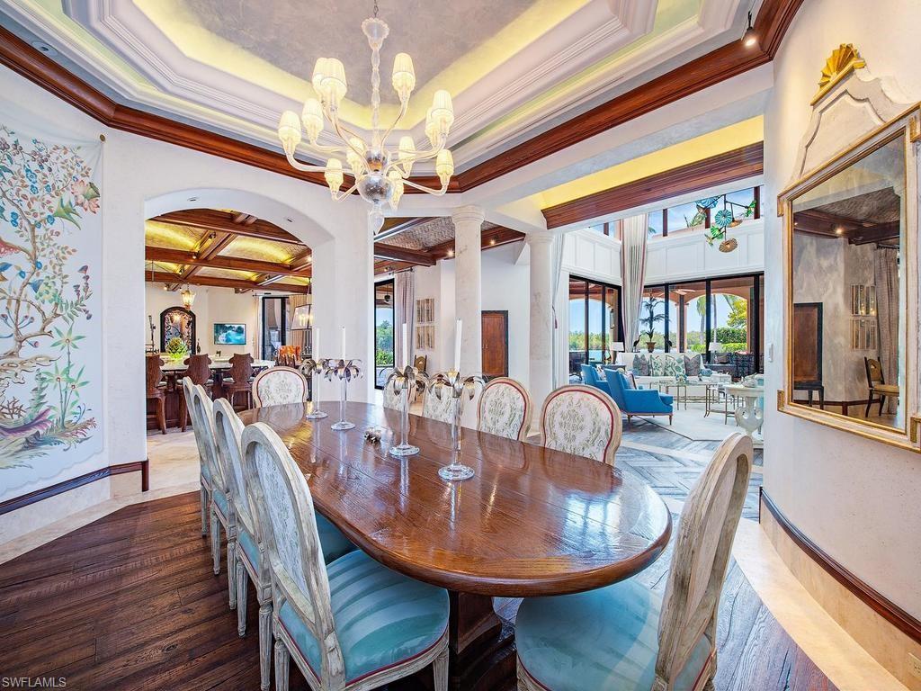 840 Admiralty Parade Naples, FL 34102 - Photo 17 of 50 a dining room with furniture a chandelier and wooden floor