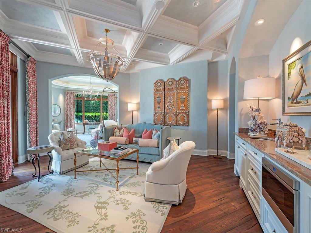 840 Admiralty Parade Naples, FL 34102 - Photo 26 of 50 a living room with furniture or chandelier and a wooden floor