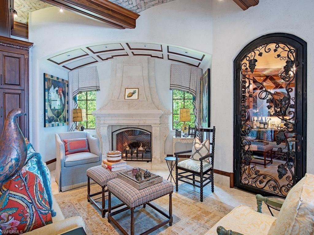 840 Admiralty Parade Naples, FL 34102 - Photo 30 of 50 a living room with furniture and a fireplace