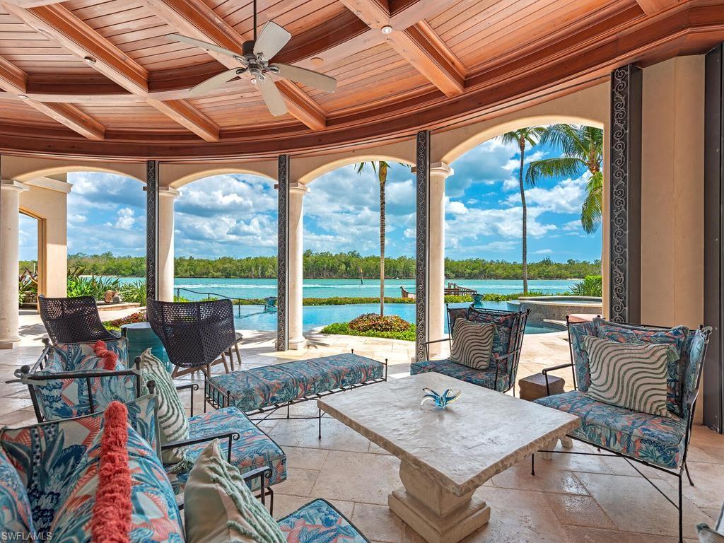 840 Admiralty Parade Naples, FL 34102 - Photo 3 of 50 a living room with furniture and floor to ceiling windows