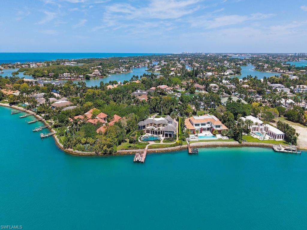 840 Admiralty Parade Naples, FL 34102 - Photo 31 of 50 an aerial view of residential houses with outdoor space and trees