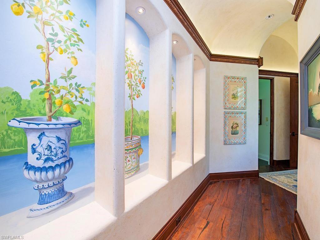840 Admiralty Parade Naples, FL 34102 - Photo 38 of 50 a view of a hallway with wooden floor and a potted plant