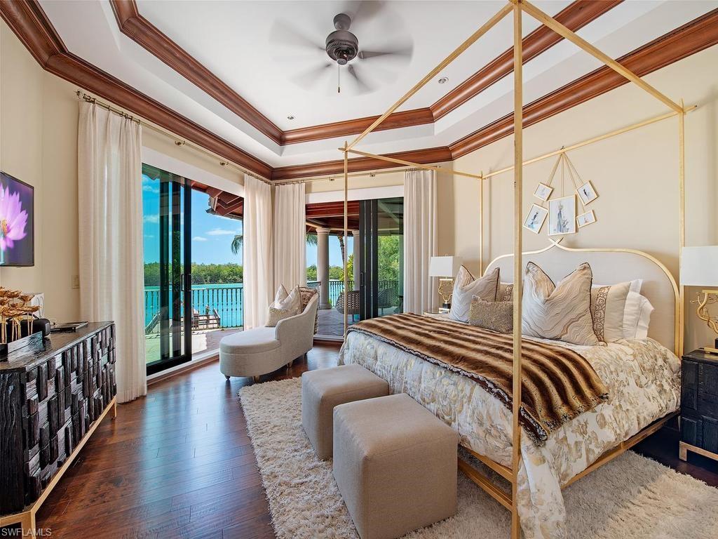 840 Admiralty Parade Naples, FL 34102 - Photo 39 of 50 a bedroom with furniture and large windows