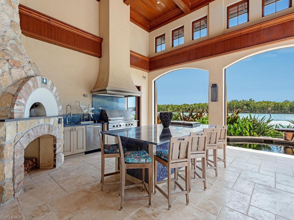 840 Admiralty Parade Naples, FL 34102 - Photo 7 of 50 a view of a patio with couches and a fireplace