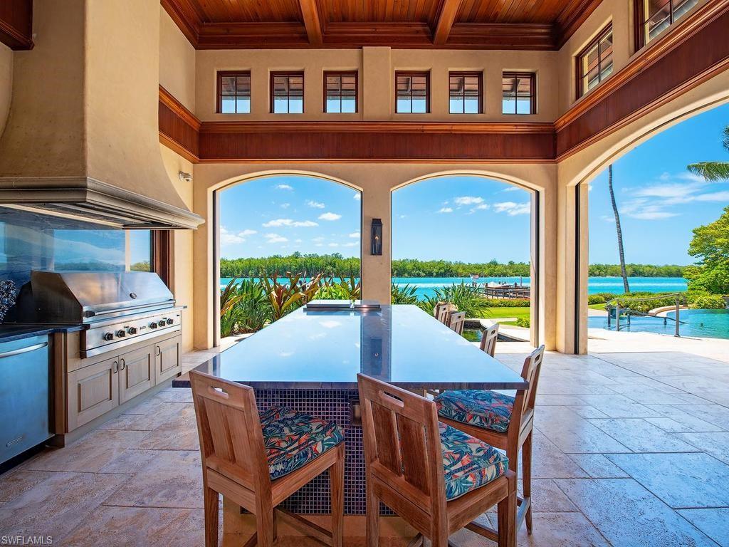 840 Admiralty Parade Naples, FL 34102 - Photo 8 of 50 a view of a patio with a table and chairs