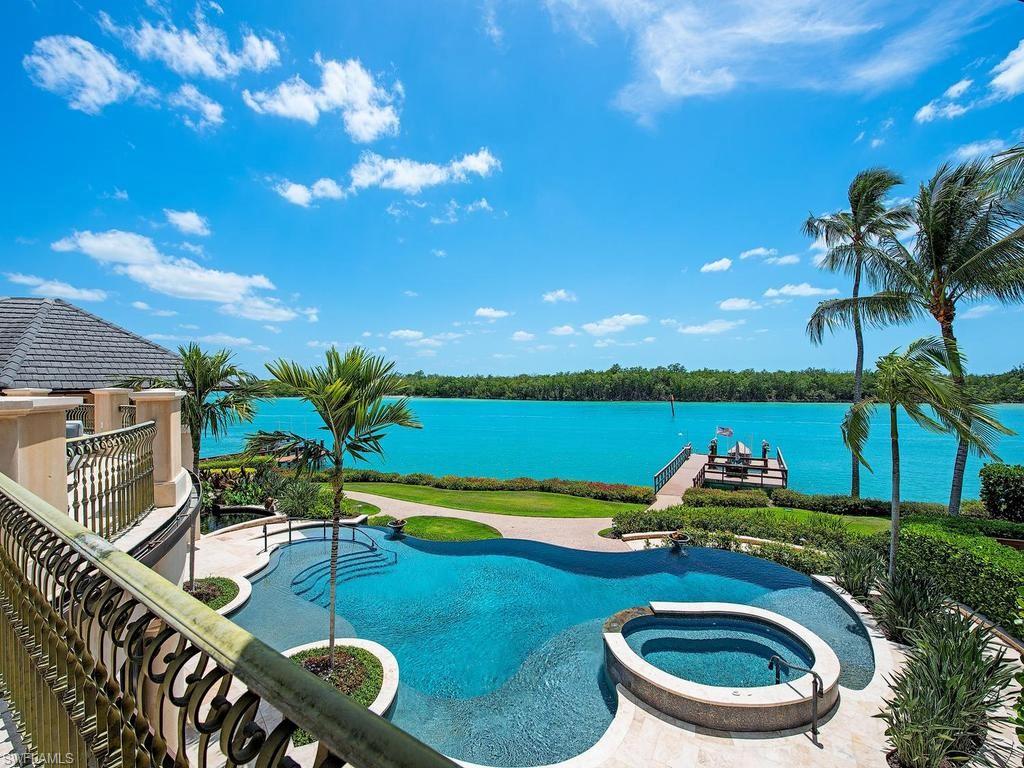 840 Admiralty Parade Naples, FL 34102 - Photo 9 of 50 a view of a swimming pool with a patio and a garden