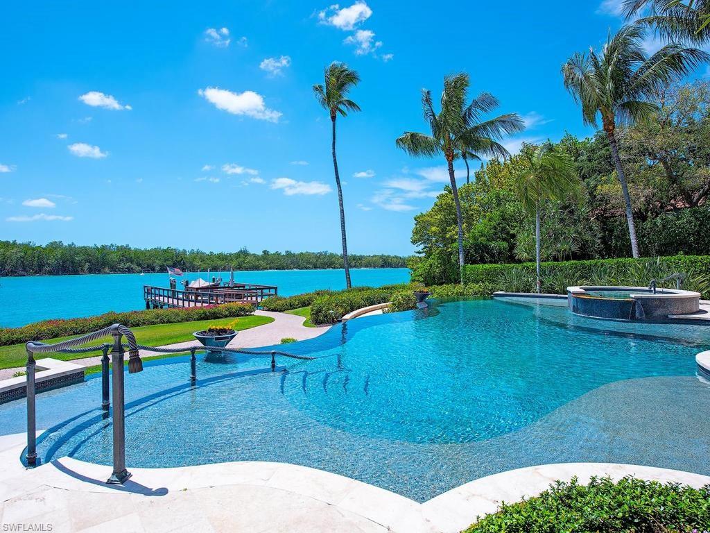 840 Admiralty Parade Naples, FL 34102 - Photo 10 of 50 a view of a swimming pool with a patio