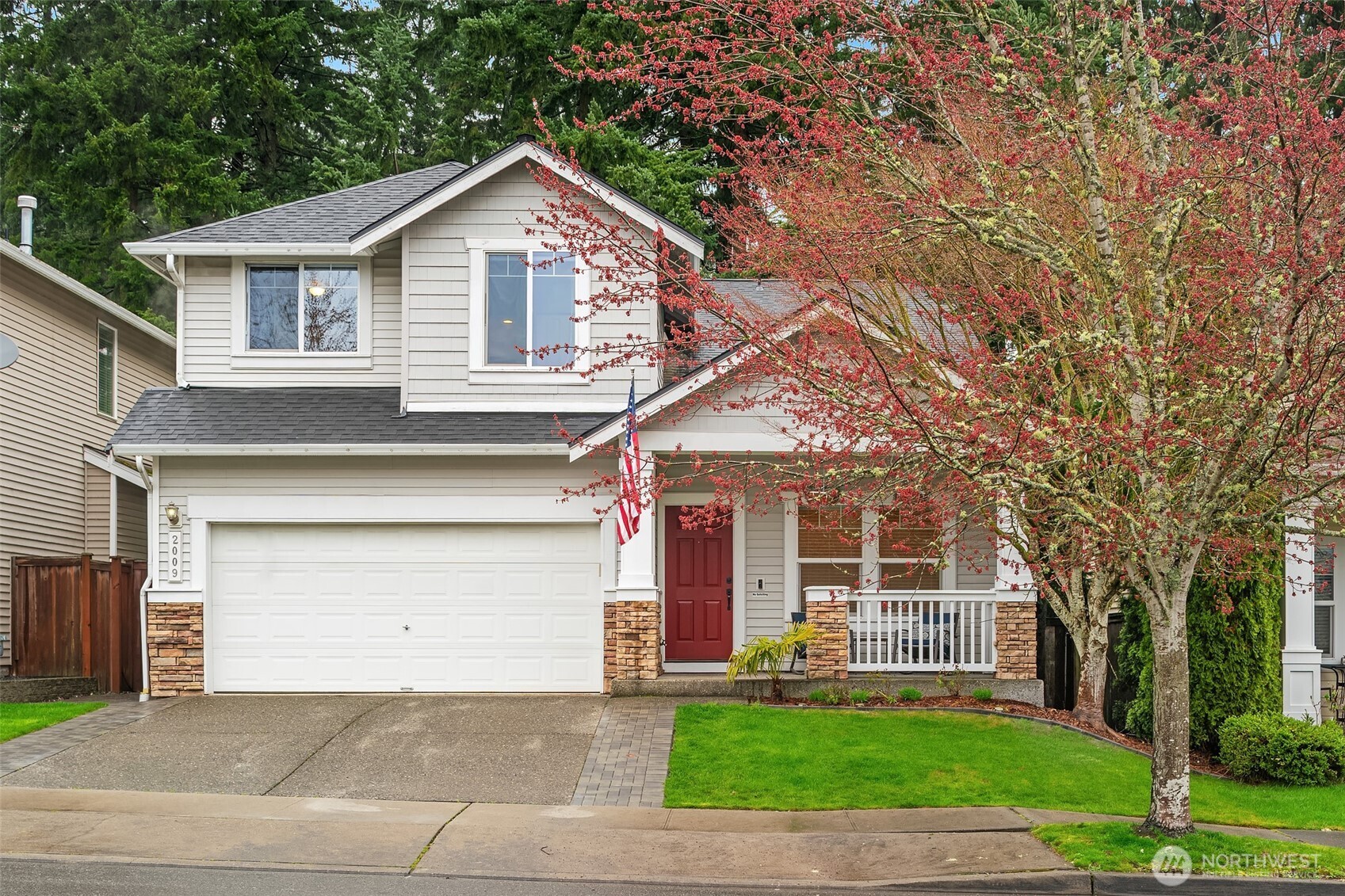 2009 62nd Loop Southeast Auburn, WA 98092 - Photo 2 of 24 a front view of a house with a yard and garage