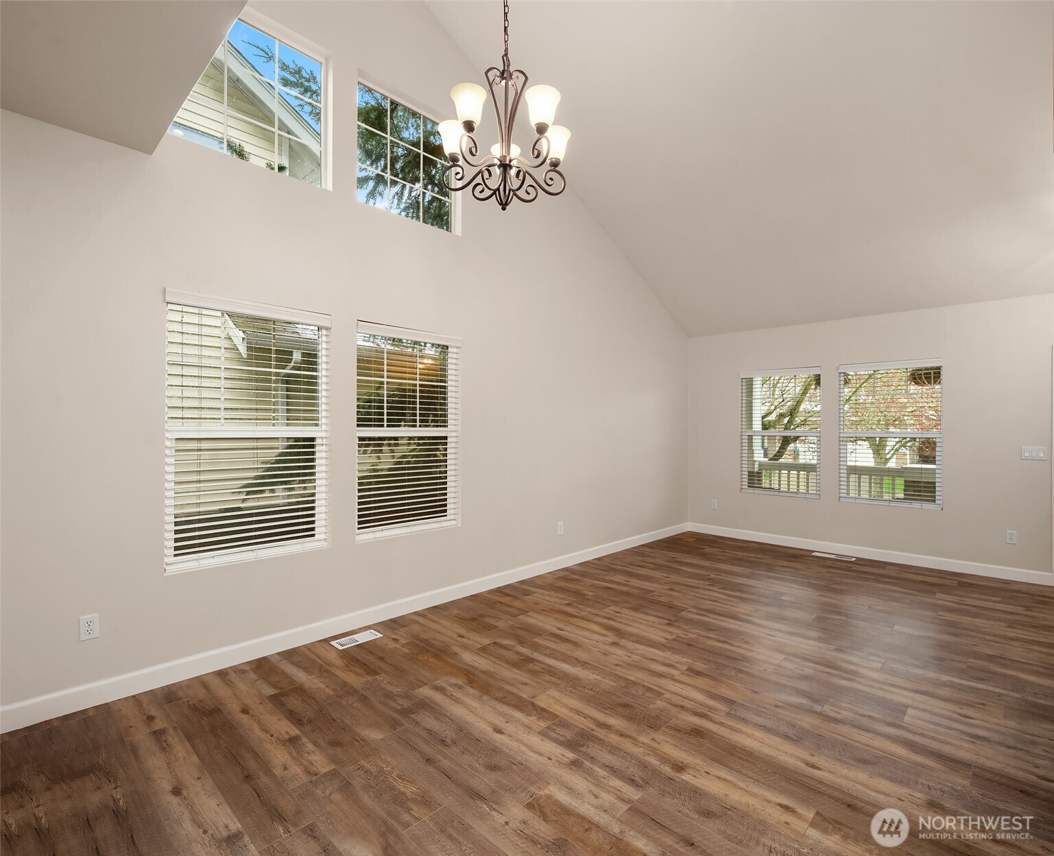 2009 62nd Loop Southeast Auburn, WA 98092 - Photo 3 of 24 a view of an empty room with wooden floor and a window